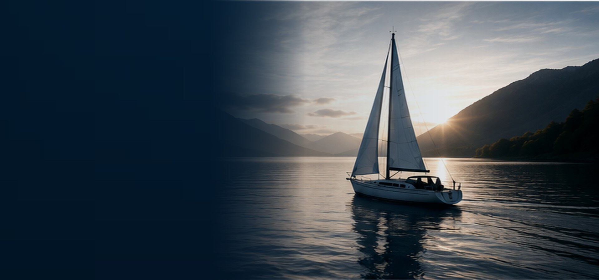 Sailing boat on calm water beneath a British mountain landscape